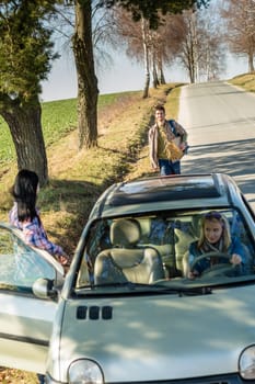 Young man road trip girl friends offer lift with car