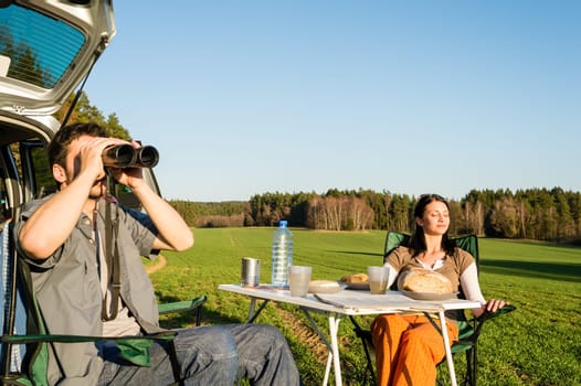 Camping car happy couple man looking telescope relax countryside picnic