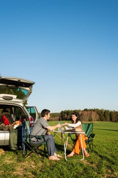 Camping car happy young couple enjoy picnic sunny countryside