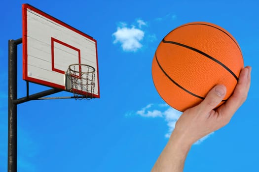 basketball hoop and human hand with ball