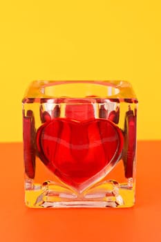 candlestick with red heart on colorful background