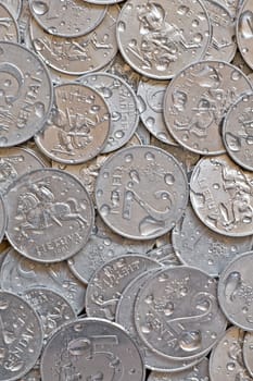 money background. close-up of a wet silver coins