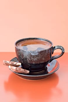 cup of coffee with two chocolate pieces