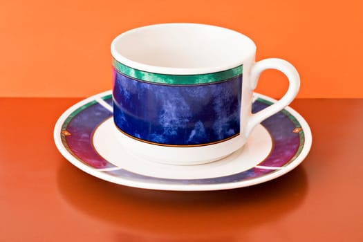 decorative tea cup on brown and orange background