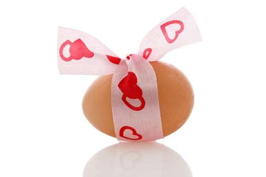brown egg with a ribbon on white background