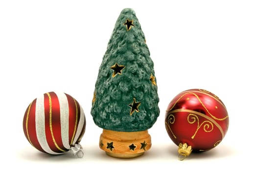 artificial christmas tree and xmas baubles on white background