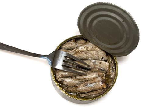 fork on iron bank with canned fish in oil