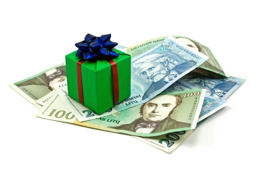 gift box on money pile. isolated on white background