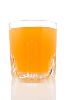 glass of juice on white background with reflection