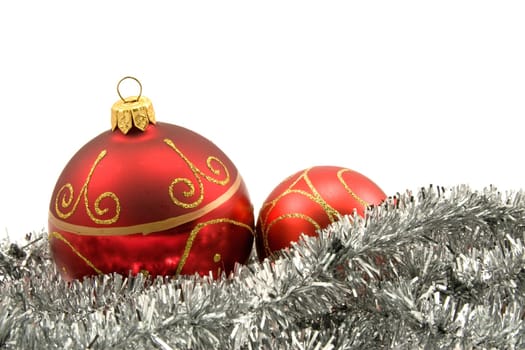 garland with christmas baubles over a white background