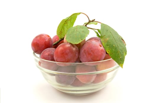 dish with plums, isolated on white background