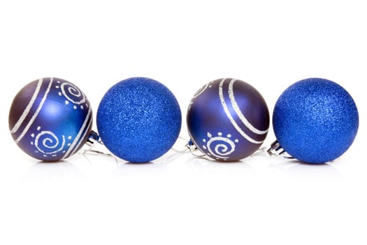 four blue cristmas baubles over a white background.
