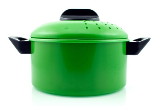 green cooking pot with reflection on white