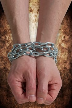 Hands chained together , isolated on a dirty background