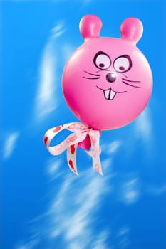 pink flying bunny balloon in a sky.