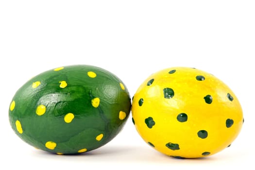 green and yellow easter eggs on white background