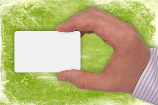hand with blank card on green background