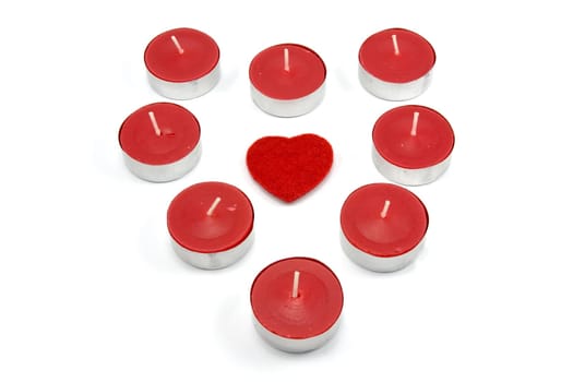 heart shape made from red candles. isolated on white