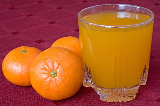 mandarines and glass of juice on the table