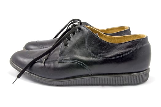 pair of black leather shoes on white background