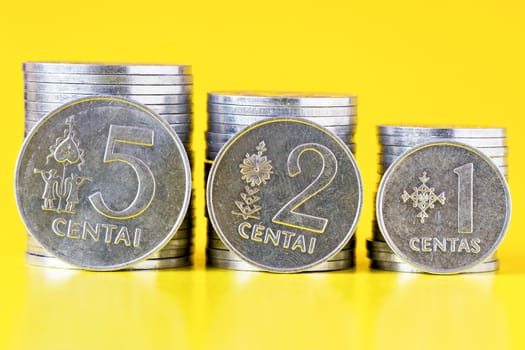 silver lithuanian coins cents, on yellow background