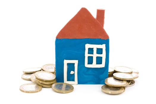 mortgaging concept. house and coins over a white background