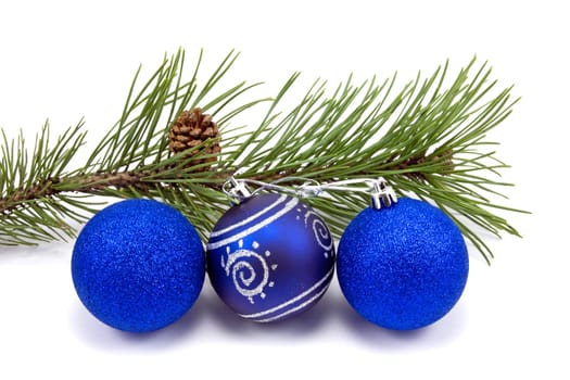 pine branch and christmas baubles on white background