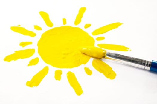 paintbrush and painted sun on white background