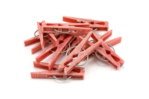 pile of plastic clothes pegs on white background