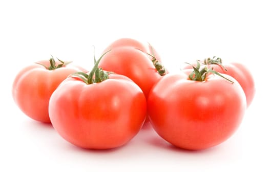 pile of red tomatoes isolated on white background
