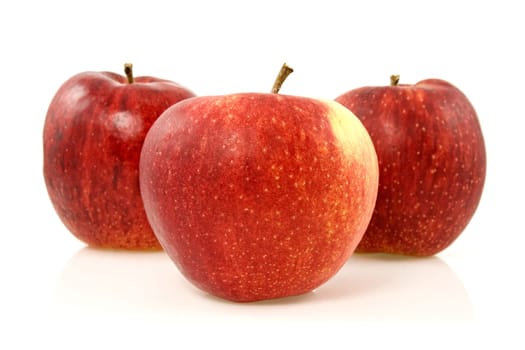 three red apples over a white background