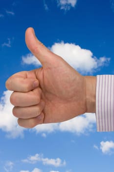success in business. thumb up on sky background