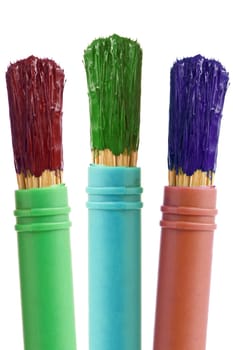 three paintbrushes with color paint. isolated on white background