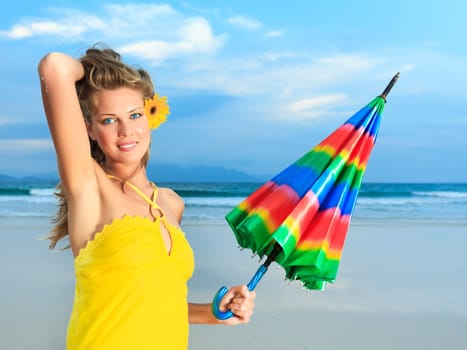 Beautiful woman in yellow dress with umbrella