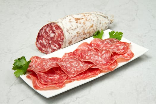 Salami sliced on marble table
