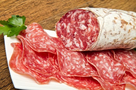 Salami sliced on wood background