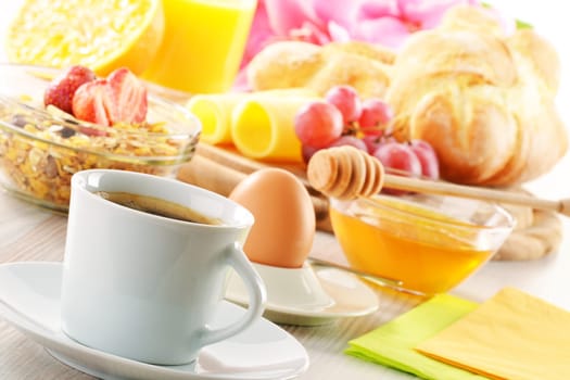 Breakfast with coffee, rolls, egg, orange juice, muesli and cheese