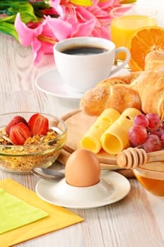 Breakfast with coffee, rolls, egg, orange juice, muesli and cheese