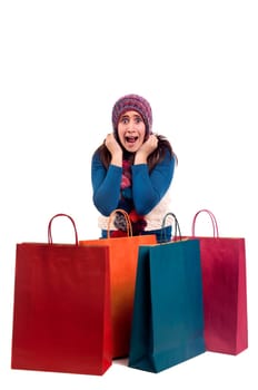 Beautiful young girl posing with shopping bags isolated in white
