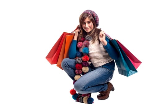 Beautiful young girl posing with shopping bags isolated in white