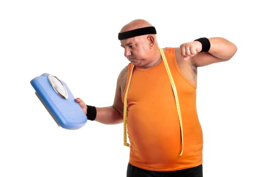Large fitness man angry with weight scale isolated in white