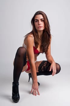 Sexy girl in lingerie posing against a light background