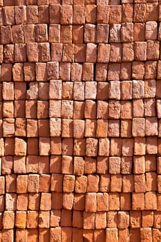 red stapled bricks give a harmonic pattern in the sun