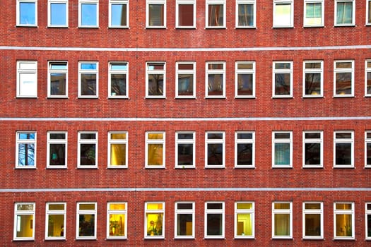 facade of office building in the evening with illuminated windows