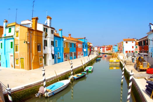 beautiful colored houses and a canal seen from an old brigde of the old fishermans  city Burano in the lagoon of Venice