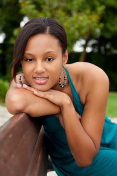 Portrait of a young beautiful african american woman sitting on a bench