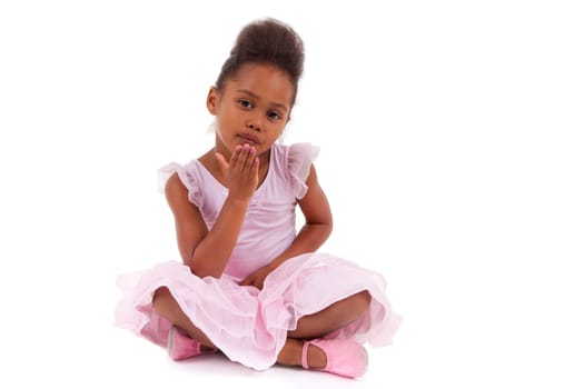 Cute little African Asian girl sitting on the floor,  isolated on white background