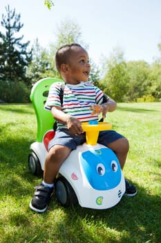 Cute little african american baby boy playing at park