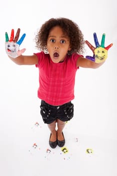 Little African Asian girl with painted hands in colorful paints