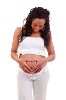 African woman holding her hands in a heart shape on her pregnant belly